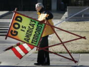 The Rev. Fred Phelps Sr. prepares to protest outside the Kansas Statehouse in Topeka, Kan., on July 1, 2007. Phelps, the founder of the Kansas church known for anti-gay protests and pickets at military funerals, died Thursday.