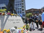 A.G. Spanos, CEO of the San Diego Chargers, leads his team as they place flowers and other mementos at the base of the Tony Gwynn &quot;Mr. Padre&quot; statue, Monday, June 16, 2014, in San Diego. Gwynn, an eight time National League batting champion with the San Diego Padres and a member of Baseball Hall of Fame, died Monday from cancer. He was 54.