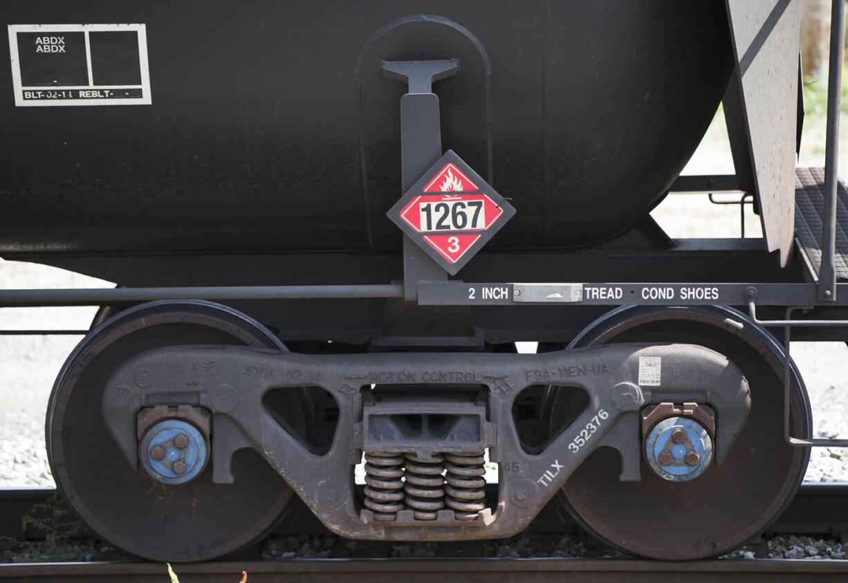 Signs indicate petroleum crude oil on train tank cars standing idle on the tracks in Philadelphia on Wednesday.