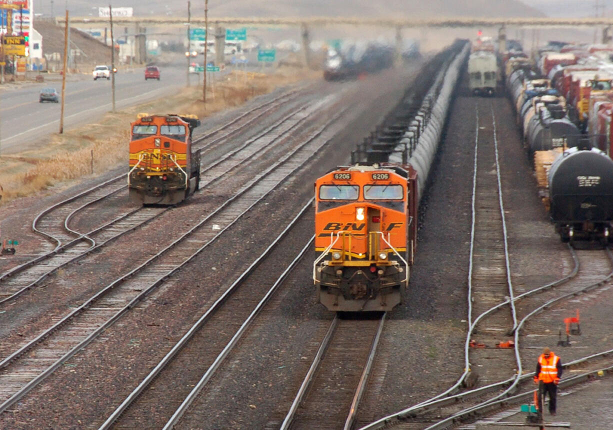 A train carrying crude oil heads west through the small town of Shelby, Mont., on Nov.