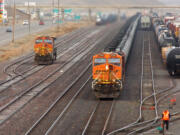 A train carrying crude oil heads west through the small town of Shelby, Mont., on Nov.