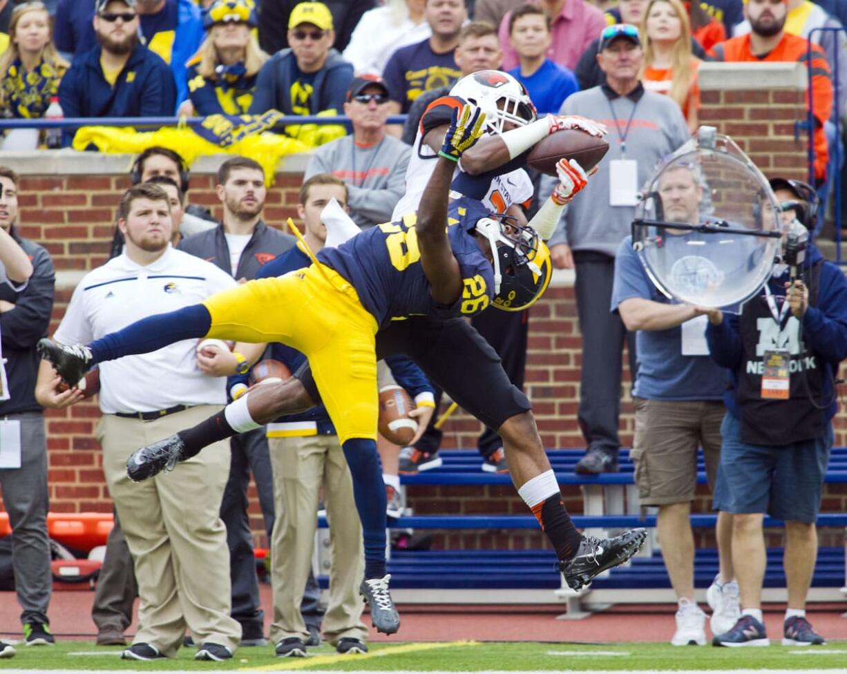 Michigan defensive back Jourdan Lewis (26) breaks up a pass intended for Oregon State wide receiver Jordan Villamin, in the second quarter of an NCAA college football game in Ann Arbor, Mich., Saturday, Sept. 12, 2015.