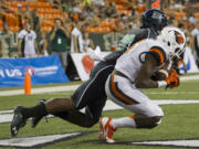 Oregon State wide receiver Victor Bolden (6) catches a pass for a touchdown while being defended by Hawaii defensive back Nick Nelson (20) in the third quarter of an NCAA college football game, Saturday, Sept. 6, 2014, in Honolulu.