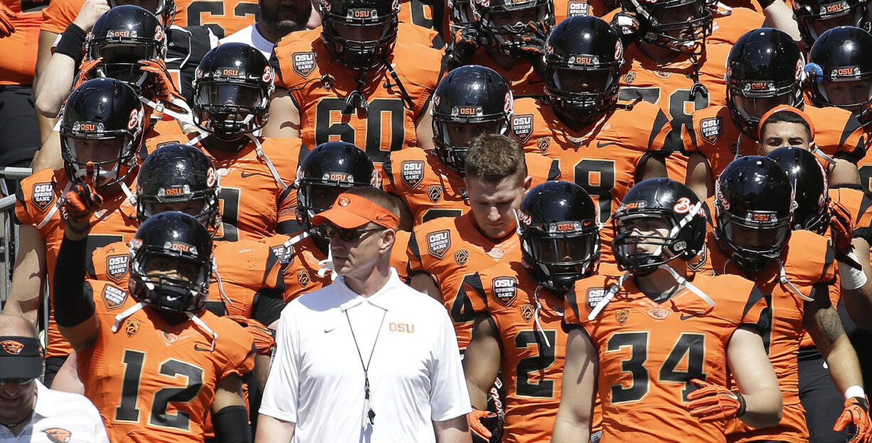 Oregon State coach Gary Andersen walks onto the field with the orange squad before their spring game in Corvallis, Ore., on Saturday, April 18, 2015.