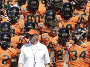 Oregon State coach Gary Andersen walks onto the field with the orange squad before their spring game in Corvallis, Ore., on Saturday, April 18, 2015.