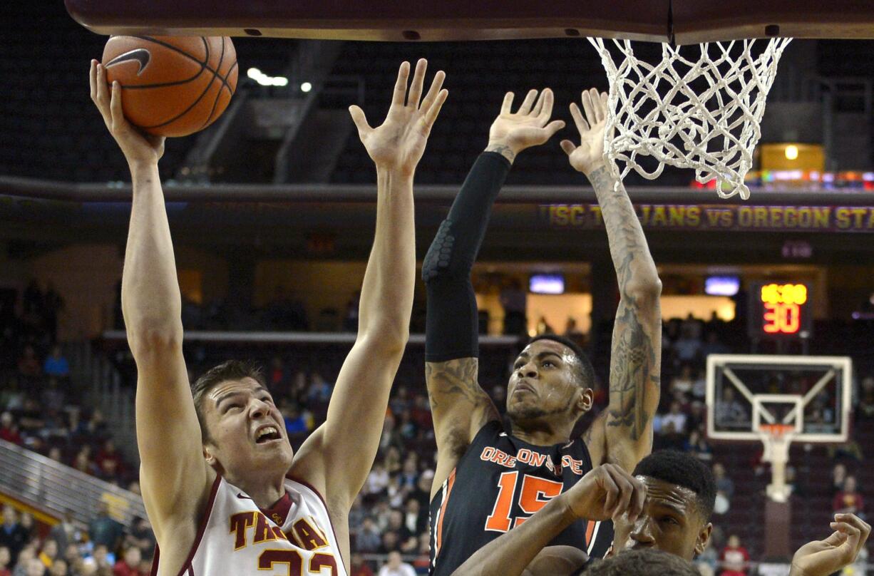 USC forward Nikola Jovanovic, left, puts up a shot as Oregon State forward Eric Moreland defends during the first half Thursday. (AP Photo/Mark J.