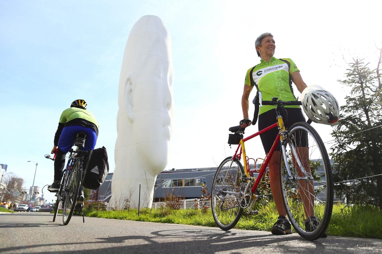 John Lok/The Seattle Times
Catherine Hennings, right, board president of Cascade Bicycle Club, pauses on the bicycle trail at Seattle's Myrtle Edwards Park, part of an urban loop she recommends.