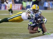 Green Bay Packers free safety Ha Ha Clinton-Dix (21) tackles Seattle Seahawks wide receiver Percy Harvin (11) after a pass reception during the first half of an NFL football game, Thursday, Sept. 4, 2014, in Seattle.