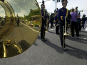 Members of Columbia River's band are reflected in sophomore Michael Hall's sousaphone before the start of the 48th annual Hazel Dell Parade of Bands in 2012.