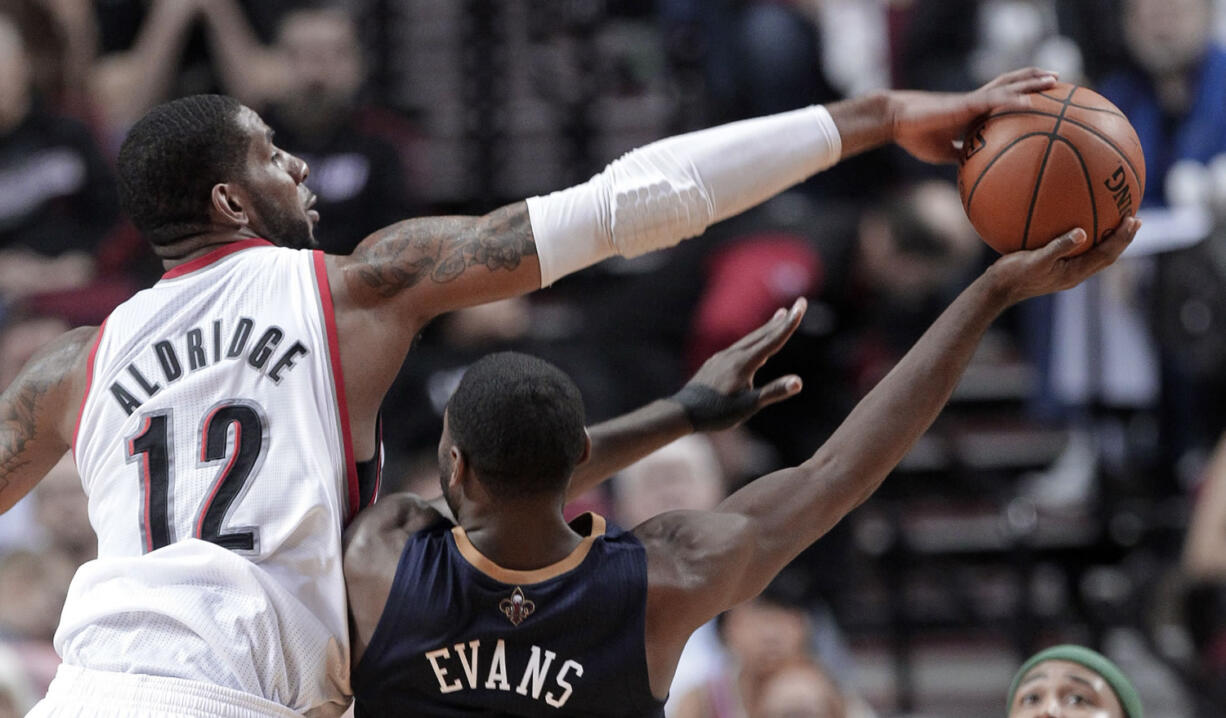 Portland Trail Blazers forward LaMarcus Aldridge, left, blocks a shot by New Orleans Pelicans guard Tyreke Evans during the second half in Portland, Ore., Sunday.