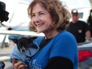 Volunteer Melanie Pozez loads rescued dogs into a Wings of Rescue plane to fly them to safe havens, at Van Nuys Airport, in Van Nuys, Calif.