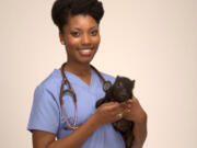 This July 29, 2015 photo provided by National Geographic Channels shows Aziza Glass, a doctor of veterinary medicine candidate at Cornell University, class of 2015, posing for a photo in Los Angeles. &quot;Vet School&quot; is a new Nat Geo Wild series that follows a group of students through rotations at prestigious Cornell University College of Veterinary Medicine. The one-hour show premieres Sept.