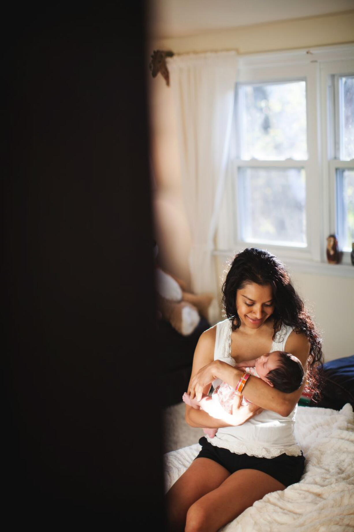 Photos from I Heart New York
This 2013 photo provided by I Heart New York shows Anzalee Rhodes holding her 10-day-old daughter Arabelle in her Long Island home. Rhodes and her husband Kristain Rhodes are hiring photographers from I Heart New York to document their experiences as their daughter grows. Hiring professional photographers to capture everyday life and not just important events such as weddings has become a lifestyles trend.