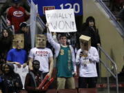 Fans hold signs after the Philadelphia 76ers won an NBA basketball game against the Detroit Pistons, Saturday, March 29, 2014, in Philadelphia. Philadelphia won 123-98, breaking a 26-game losing streak.