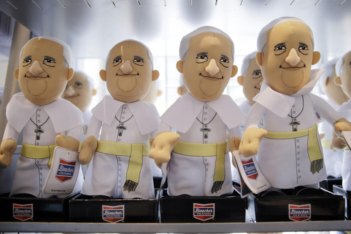 Pope Francis dolls are displayed at the World Meeting of Families souvenir store ahead of the Pope's scheduled visit, Tuesday, Sept. 22, 2015, in Philadelphia. The World Meeting of Families which officially opened Tuesday is described by organizers as a conference that blends prayer, religious instruction and faith-themed lectures as the world's largest gathering of Catholic families.