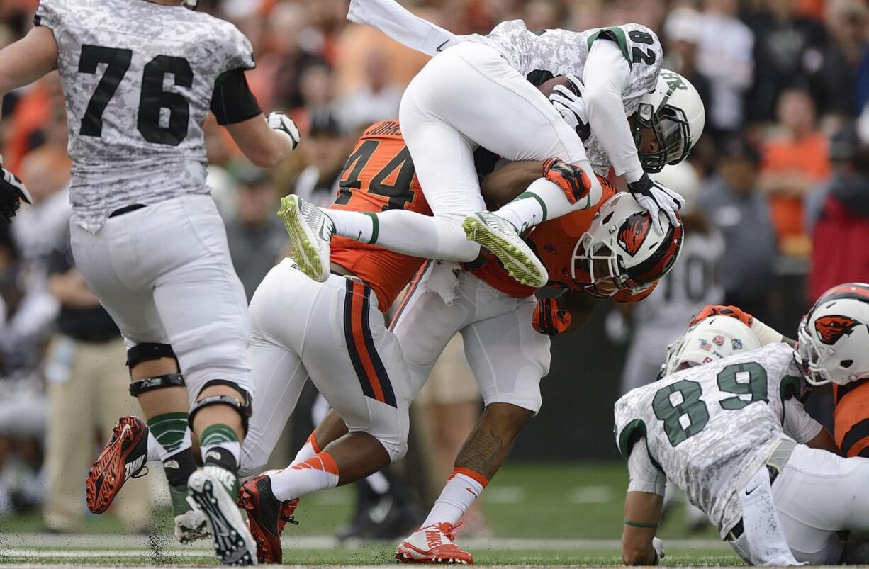 Portland State receiver Darnell Adams (82) is tackled by Oregon State safety Justin Strong during an NCAA college football game in Corvallis, Ore., Saturday, Aug. 30, 2014.