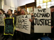 University of Oregon student Samantha Cohen, center, joins a hundred fellow protesters in the lobby of Johnson Hall on the UO campus in Eugene, Ore., Thursday to demand answers from school officials in the wake of allegations of sexual assault by three UO basketball players.