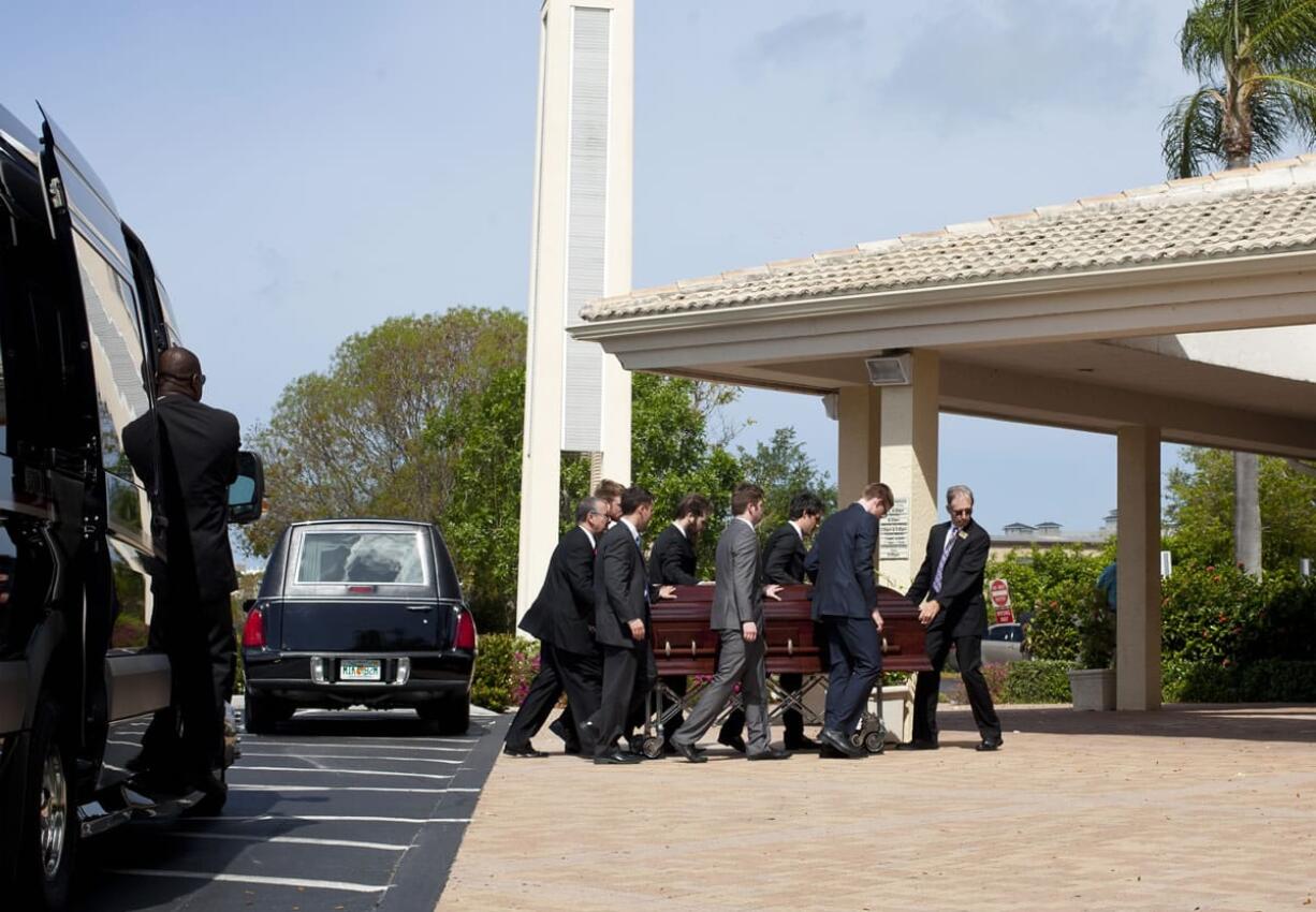 Pallbearers carry a casket into Saint John the Evangelist Catholic Church for the funeral service for Jack Ramsay in Naples, Fla. Ramsay, a Hall of Fame coach who led the Portland Trail Blazers to the 1977 NBA championship died on April 28, following a long battle with cancer.