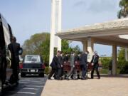 Pallbearers carry a casket into Saint John the Evangelist Catholic Church for the funeral service for Jack Ramsay in Naples, Fla. Ramsay, a Hall of Fame coach who led the Portland Trail Blazers to the 1977 NBA championship died on April 28, following a long battle with cancer.