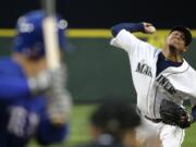 Seattle Mariners starting pitcher Felix Hernandez throws to a Texas Rangers batter during the fifth inning Saturday, April 18, 2015, in Seattle.