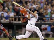 Seattle Mariners' Kyle Seager watches his three-run home run in front of Boston Red Sox catcher A.J. Pierzynski during the fourth inning of a baseball game Tuesday, June 24, 2014, in Seattle.