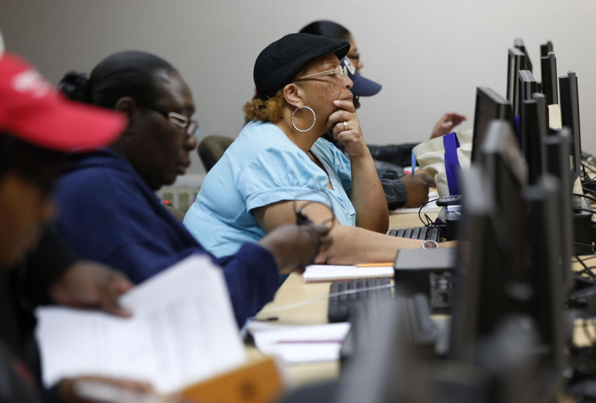 Student Sharron Foreman, center, works on a computer alongside classmates during a remedial mathematics course at Baltimore City Community College on March 12 in Baltimore.