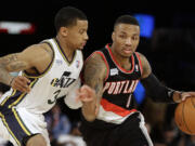 Team Hill's Damian Lillard of the Portland Trail Blazers, right, moves the ball against Team Webber's Trey Burke of the Utah Jazz during the Rising Star NBA All Star Challenge Basketball game, Friday, Feb. 14, 2014, in New Orleans.