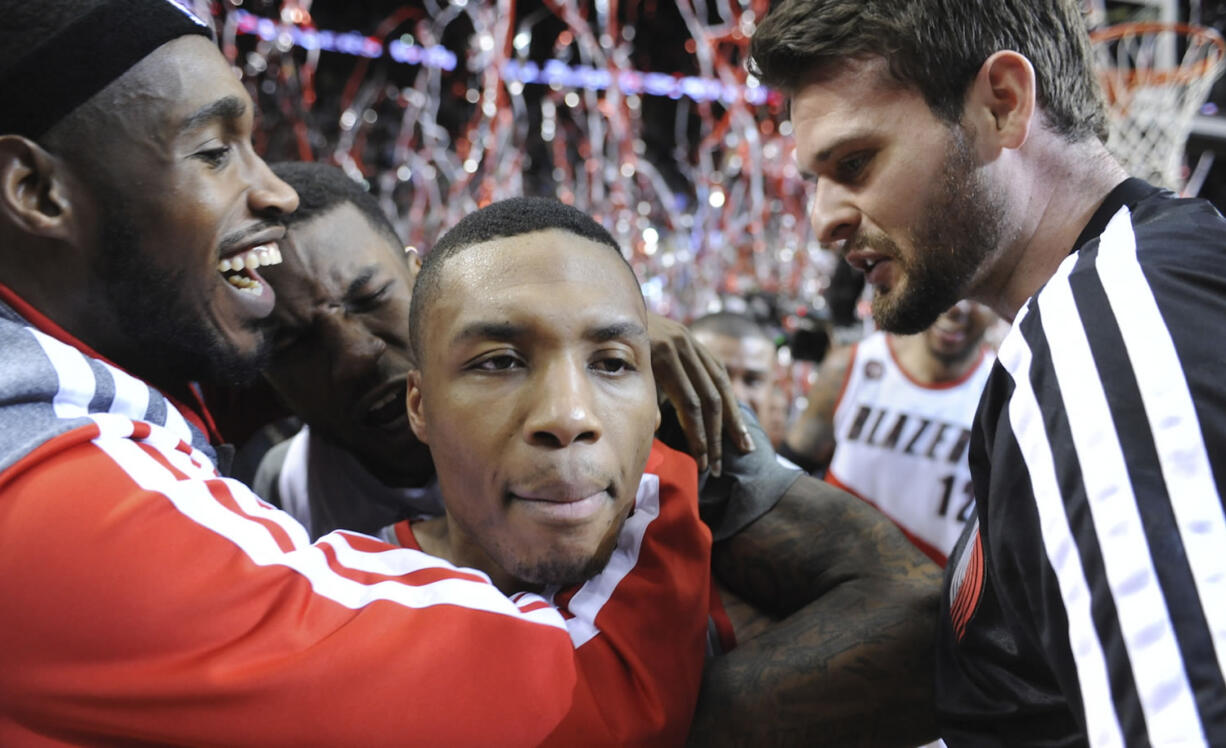 Portland Trail Blazers' Damian Lillard, center, celebrates his winning shot against the Houston Rockets on Friday.