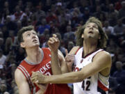 Houston Rockets center Omer Asik, left, and Portland Trail Blazers center Robin Lopez jockey for position on a free throw during the first half of Game 3 of an NBA basketball first-round playoff series in Portland, Ore., Friday, April 25, 2014.