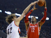 Houston Rockets' Dwight Howard (12) shoots against Portland Trail Blazers' Robin Lopez (42) during the first half of Game 4 Sunday.