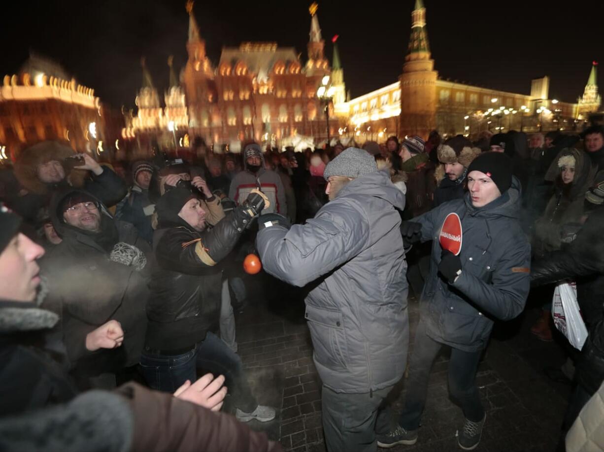 Supporters and opponents of Russian opposition activist and anti-corruption crusader Alexei Navalny fight each other during unsanctioned protest Tuesday in Manezhnaya Square in Moscow, Russia. The unsanctioned protest came hours after Alexei Navalny was found guilty of fraud and given a suspended sentence.