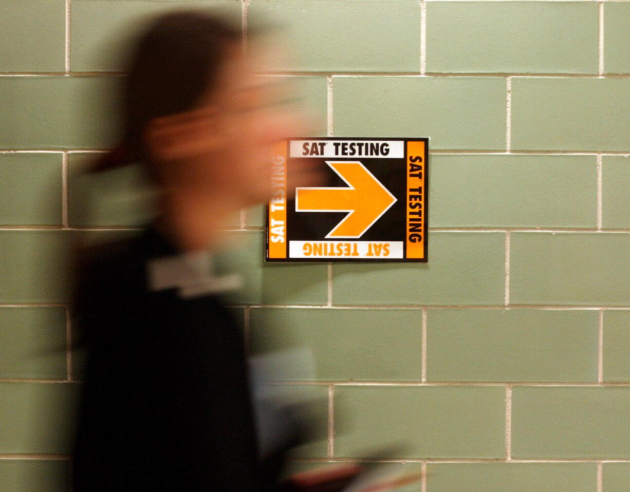 File- This March 12, 2005, file photo shows a student leaving after taking the SAT at Upper Arlington High School in Upper Arlington, Ohio. Student performance on the SAT college entrance exam is lagging, continuing a mostly downward trend over the last five years. The College Board says in a report that a record number of students took the exam.