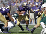 Washington's Myles Gaskin (9) tries to break through a hole on a run against Sacramento State in the first half of an NCAA college football game Saturday, Sept. 12, 2015, in Seattle.