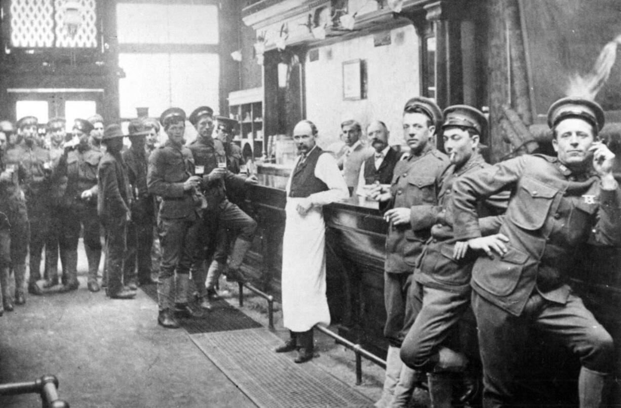 Military men from the Vancouver Barracks belly up to the bar at the downtown Log Cabin Saloon on Sixth Street, a popular drinking hole for soldiers.