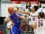 Washington State's Dexter Kernich-Drew (10) challenges a pass by San Jose State's Andrew Vollert during the second half in Pullman on Sunday, Dec. 21, 2014. Washington State won 82-53.