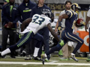 St. Louis Rams' Tavon Austin, right, returns a put 75-yards for a touchdown past Seattle Seahawks safety Kelcie McCray during the third quarter of an NFL football game Sunday, Sept. 13, 2015, in St. Louis. (AP Photo/L.G.