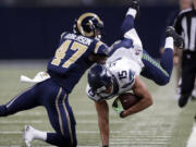 Seattle Seahawks wide receiver Jermaine Kearse, right, is stopped by St. Louis Rams cornerback Marcus Roberson after catching a pass for a 21-yard gain during the fourth quarter of an NFL football game Sunday, Sept. 13, 2015, in St. Louis.