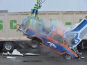 Seahawk fans at Scrap-It, a recycling business in Ferndale, destroy a 1985 Ford Bronco, painted in Denver Bronco colors Wednesday.