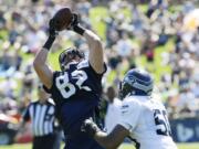 Seattle Seahawks' tight end Luke Willson, left, makes a catch as outside linebacker K.J. Wright, right, defends, during NFL football training camp, Thursday, July 31, 2014, in Renton, Wash. (AP Photo/Ted S.