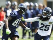 Seattle Seahawks cornerback Richard Sherman, right, defends wide receiver Ricardo Lockette during organized team activity, Tuesday, in Renton.