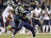 Seattle Seahawks' Jeremy Lane (20) runs after intercepting a Chicago Bears pass late in the first half of a preseason in August. Lane was put on the injured reserve list, adding some question to the depth of the Seahawks' secondary going forward.