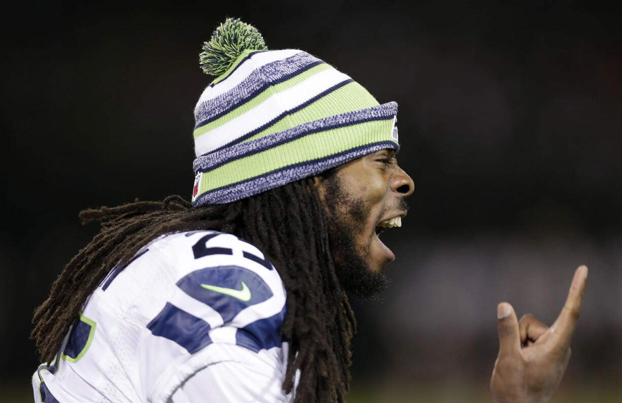 Seattle Seahawks cornerback Richard Sherman yells on the sideline during the second half of an NFL preseason football game against the Oakland Raiders in Oakland, Calif., Thursday, Aug. 28, 2014.