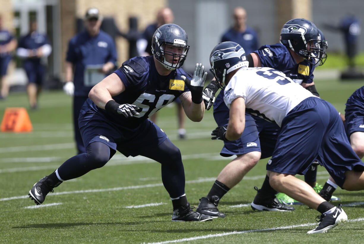 Seattle Seahawks rookie tackle Justin Britt, left, squares off against rookie defensive end Cody Bauer, right, during practice drills Friday atl rookie mini camp in Renton. (AP Photo/Ted S.