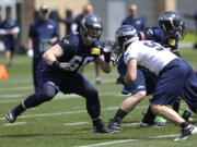 Seattle Seahawks rookie tackle Justin Britt, left, squares off against rookie defensive end Cody Bauer, right, during practice drills Friday atl rookie mini camp in Renton. (AP Photo/Ted S.