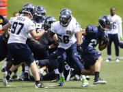 Seattle Seahawks rookie linebacker Kevin Pierre-Louis (58) takes part in a scrimmage Friday.