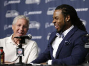 Seattle Seahawks' Richard Sherman, right, laughs during a news conference as he sits with head coach Pete Carroll Wednesday at the team's headquarters in Renton.