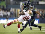 Kam Chancellor (31) of the Seattle Seahawks makes a hard hit on Vernon Davis of the San Francisco 49ers in the NFC Championship game at CenturyLink Field on Jan.