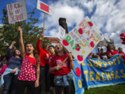 Sydney Stumpf, left, and Aderyn Kee, both students at Loyal Heights Elementary School, protest after marching with parents, students and supporters of teachers from Pioneer Square to the John Stanford Center on Tuesday in Seattle. Teachers who had been on the picket lines for a week will be back in the classroom today. (Ellen M.