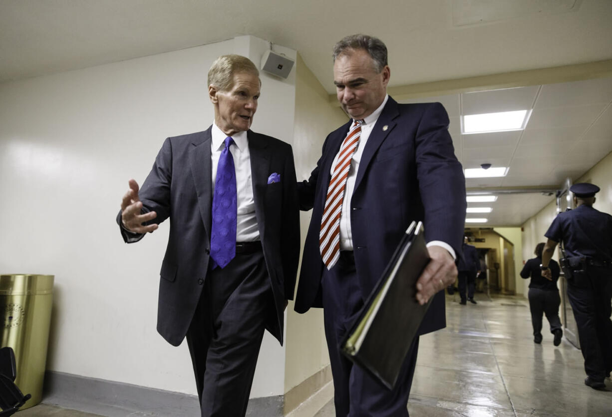 Bill Nelson, D-Fla., left, and Sen. Tim Kaine, D-Va., right, leave the Senate after a series of votes to confirm federal judicial appointees at the Capitol in Washington on Tuesday, June 3, 2014.