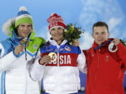 Men's snowboard parallel giant slalom medalists, from left, Slovenia's Zan Kosir, bronze, Russia's Vic Wild, gold, and Switzerland's Nevin Galmarini, silver, pose with their medals at the 2014 Winter Olympics in Sochi, Russia, Wednesday, Feb. 19, 2014.